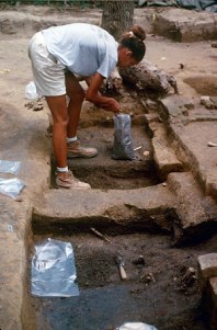 Archaeologist collecting soil, 1995